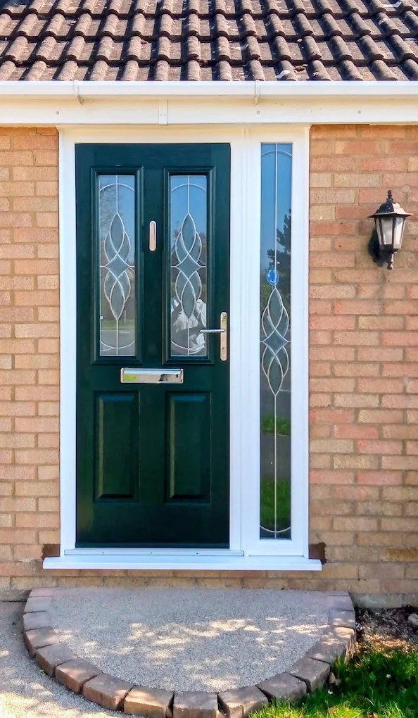 Green composite front door with decorative glass, fitted by Glazing Trade Supplies